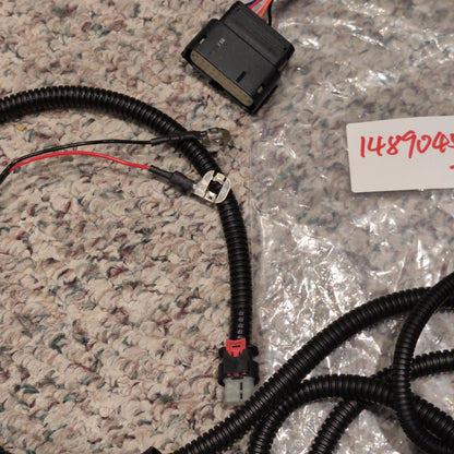 Electrical wiring harness on a textured surface with a label in the background.